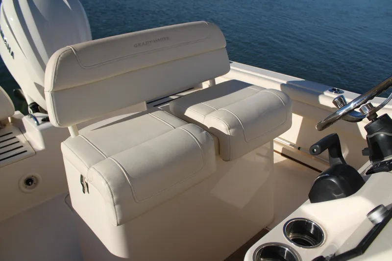 Slide: The Image of 2024 Grady-White Fisherman 216 boat interior with cushioned seating and steering wheel. - 19