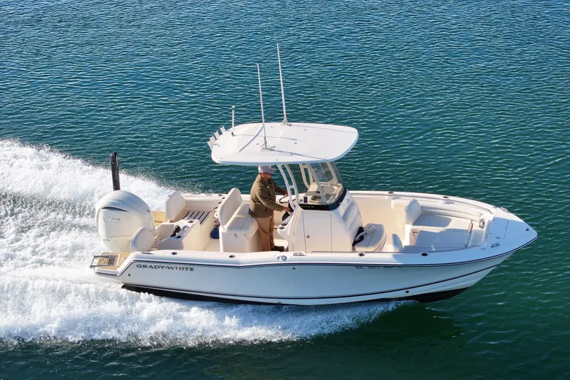 Slide: The Image of 2024 Grady-White Fisherman 216 boat cruising on a serene lake. - 2