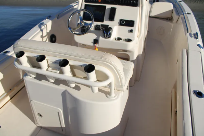 Slide: The Image of 2024 Grady-White Fisherman 216 boat interior with rod holders and steering console. - 20