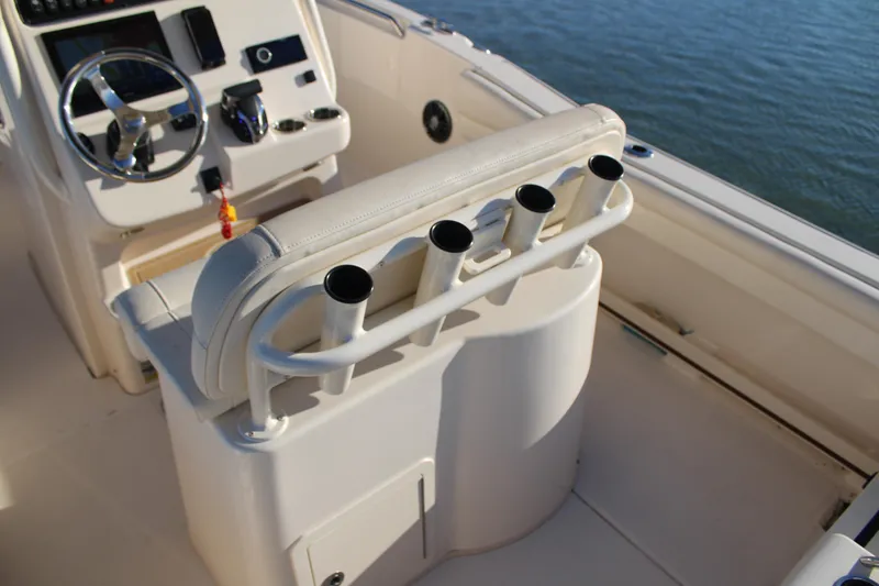 Slide: The Image of 2024 Grady-White Fisherman 216 boat interior with steering console and rod holders. - 21