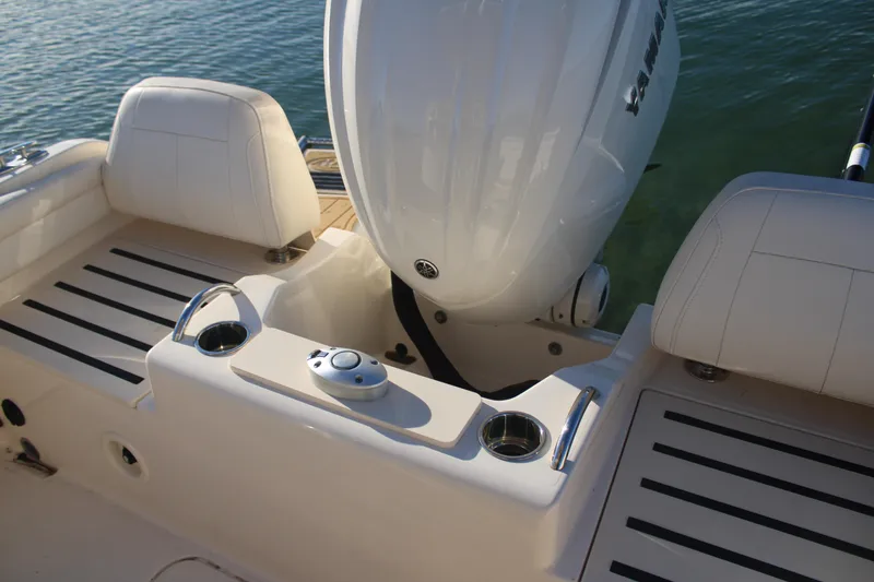 Slide: The Image of 2024 Grady-White Fisherman 216 boat interior with Yamaha engine, featuring seating and cup holders. - 22