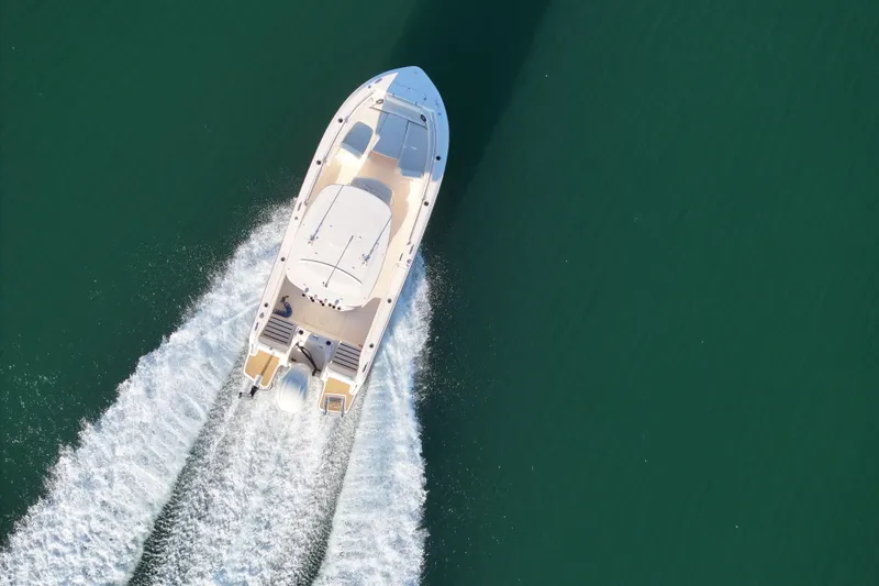 Slide: The Image of 2024 Grady-White Fisherman 216 boat on calm water, side view. - 6