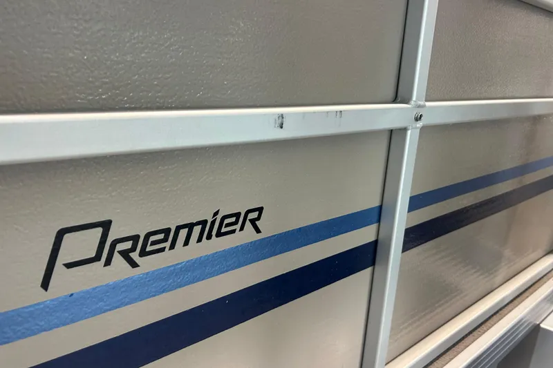 Slide: The Image of 2009 Premier 240 SunSpree boat with blue stripes and logo detail. - 15