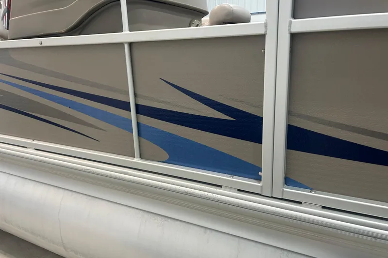 Slide: The Image of 2009 Premier 240 SunSpree pontoon boat with blue and gray side graphics. - 19