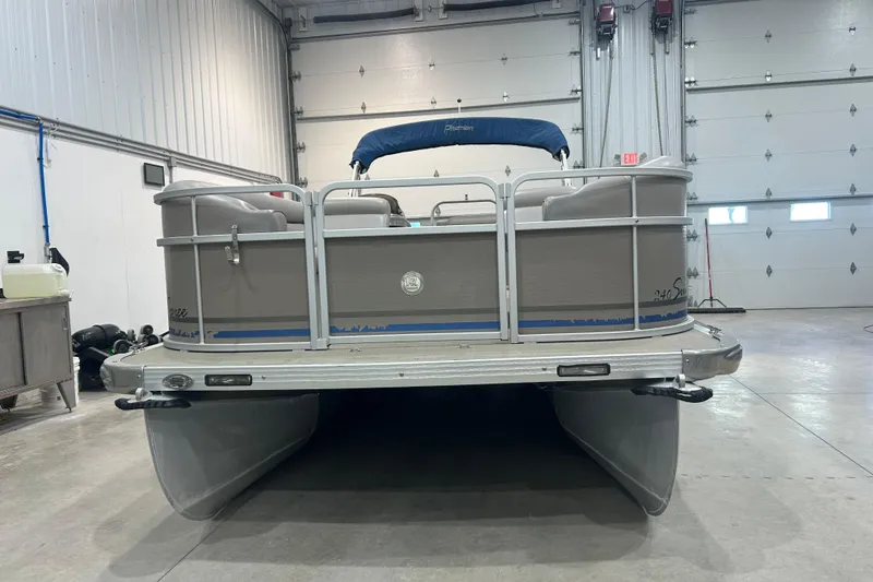 Slide: The Image of 2009 Premier 240 SunSpree pontoon boat in a garage, rear view. - 2