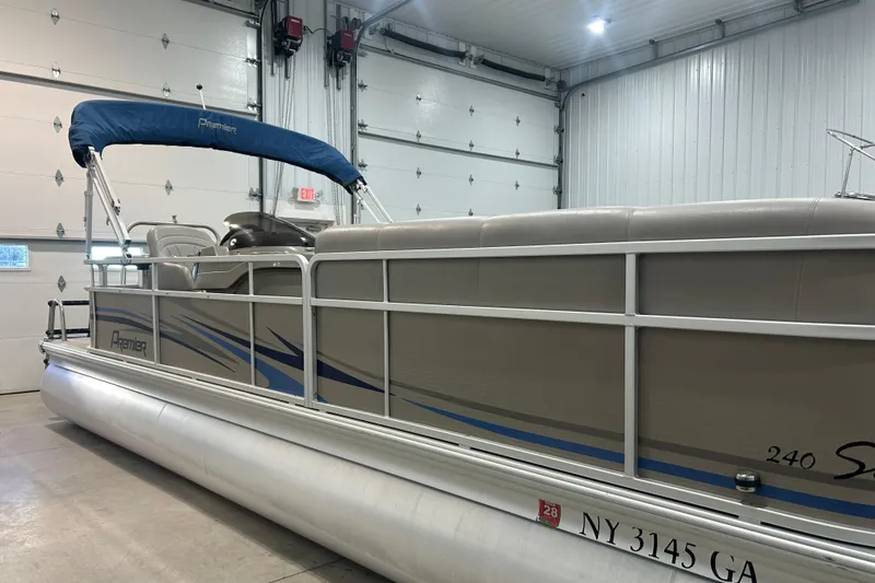 Slide: The Image of 2009 Premier 240 SunSpree pontoon boat in a garage, side view. - 23