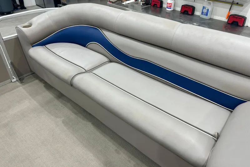 Slide: The Image of Gray and blue seating on 2009 Premier 240 SunSpree boat, featuring cup holder. - 27