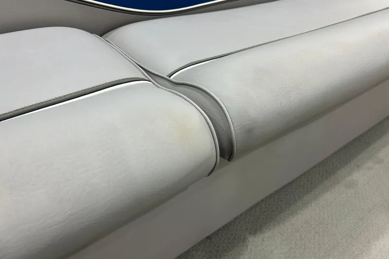 Slide: The Image of 2009 Premier 240 SunSpree boat seat with light gray upholstery and subtle stitching details. - 29