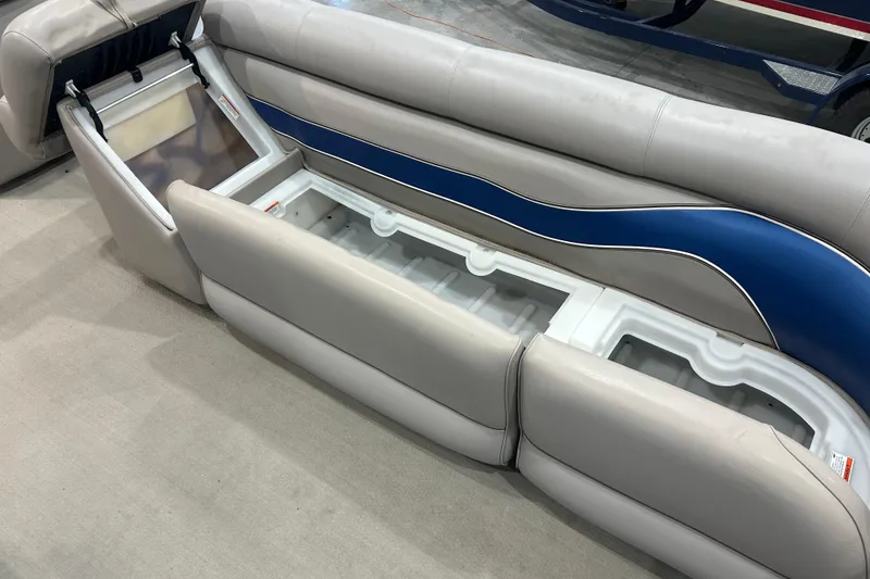 Slide: The Image of 2009 Premier 240 SunSpree boat seat storage compartment with blue and gray upholstery. - 31