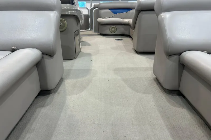 Slide: The Image of Interior of a 2009 Premier 240 SunSpree boat with gray seating and carpet. - 33