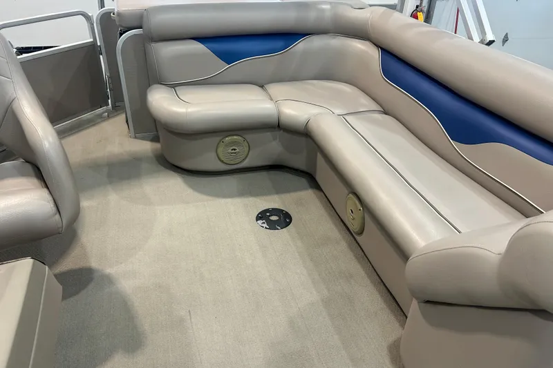 Slide: The Image of 2009 Premier 240 SunSpree boat interior with beige and blue seating. - 35
