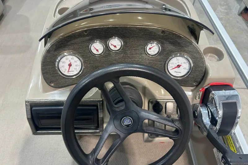 Slide: The Image of 2009 Premier 240 SunSpree boat dashboard with steering wheel and gauges. - 36