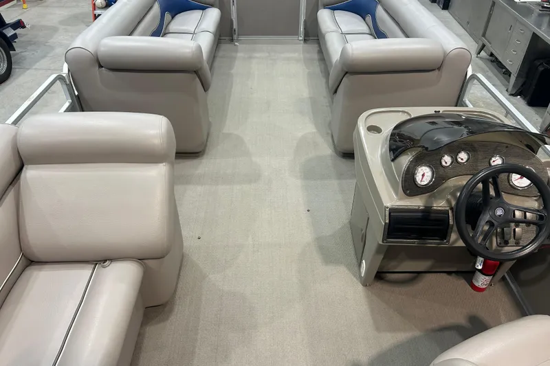 Slide: The Image of Interior of a 2009 Premier 240 SunSpree pontoon boat with beige seating and control panel. - 38