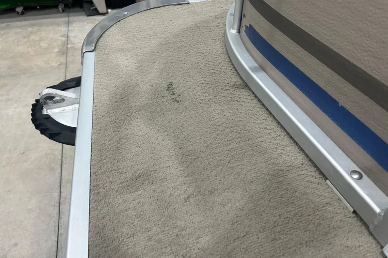 Slide: The Image of 2009 Premier 240 SunSpree boat deck with carpet and metal trim detail. - 4