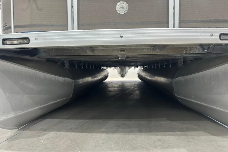 Slide: The Image of Underneath view of a 2009 Premier 240 SunSpree pontoon boat, showcasing its pontoons and structure. - 50