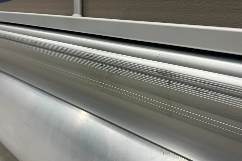 Slide: The Image of Close-up of 2009 Premier 240 SunSpree aluminum siding with visible scratches. - 8