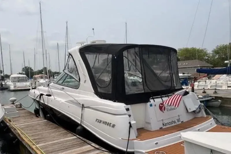 Slide: The Image of 2007 Four Winns 378 Vista yacht docked at a marina with American flag. - 14