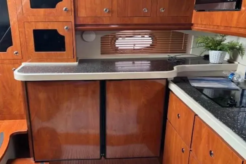 Slide: The Image of 2007 Four Winns 378 Vista yacht interior with wooden cabinetry and countertop. - 20