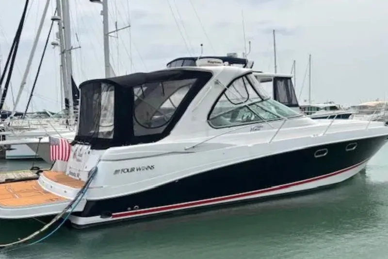 Slide: The Image of 2007 Four Winns 378 Vista yacht docked in marina, featuring sleek design and black canopy. - 21