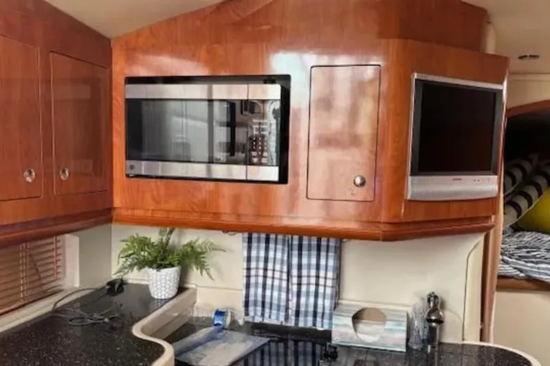 Slide: The Image of Interior of 2007 Four Winns 378 Vista yacht with microwave and TV in wooden cabinetry. - 8