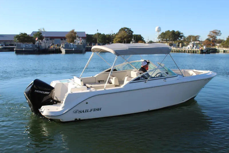 The Image of 2024 Sailfish 226DC boat on calm water with Mercury engine. - 0