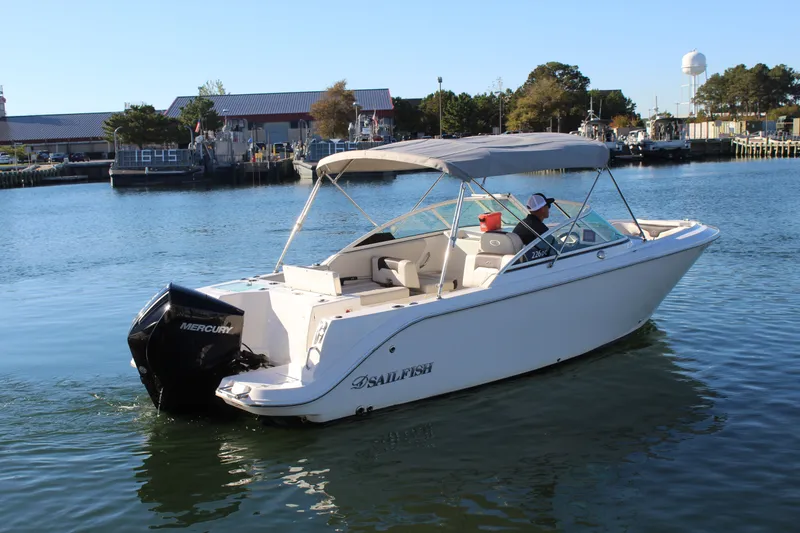 Slide: The Image of 2024 Sailfish 226DC boat on calm water. - 10