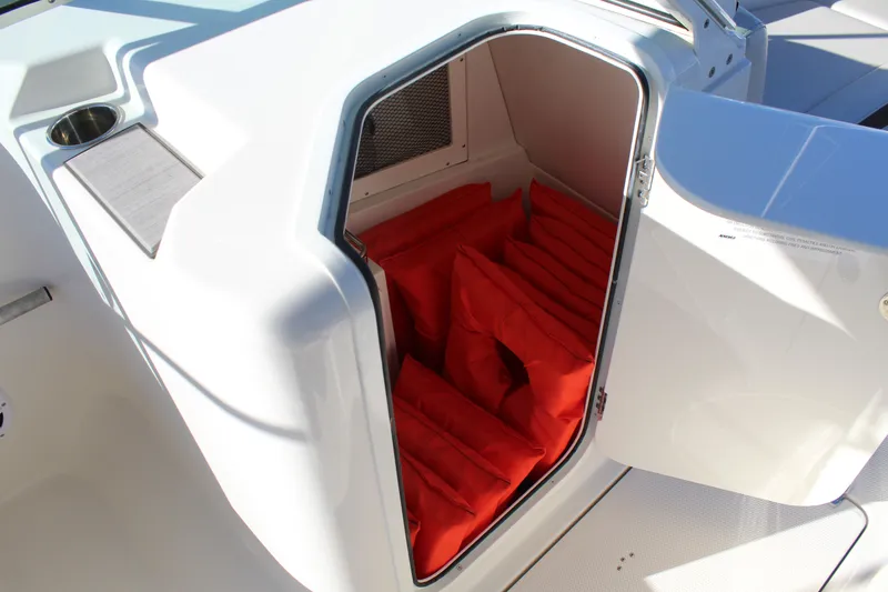 Slide: The Image of Storage compartment with red life jackets on Sailfish 226DC 2024. - 17