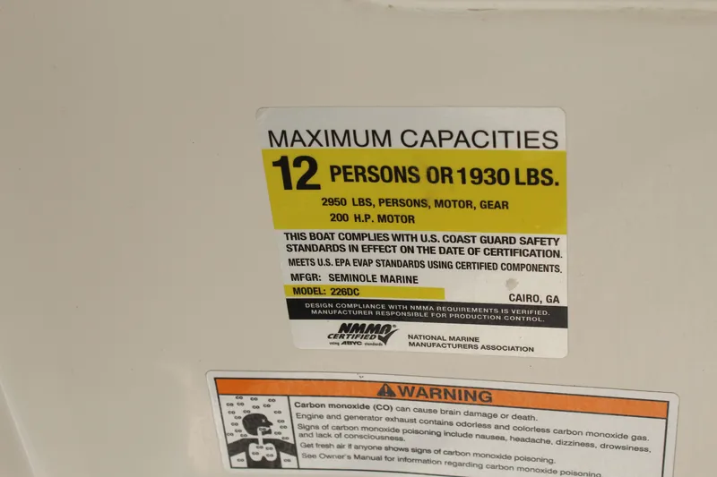 Slide: The Image of Capacity label for 12 persons or 1930 lbs on a Sailfish 226DC boat. - 19