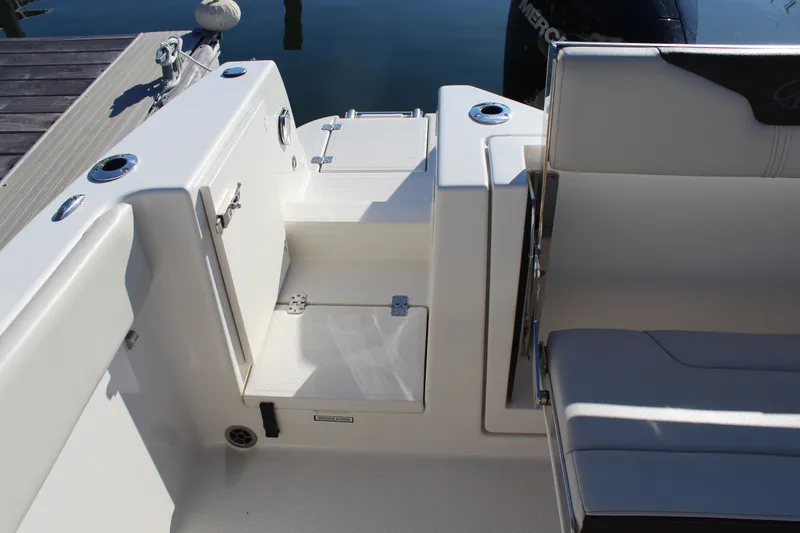 Slide: The Image of Sailfish 226DC 2024 boat, seating area and storage at dock. - 20