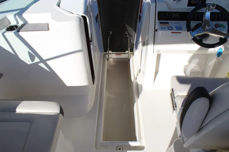 Slide: The Image of Interior of 2024 Sailfish 226DC with storage compartment and helm console. - 23