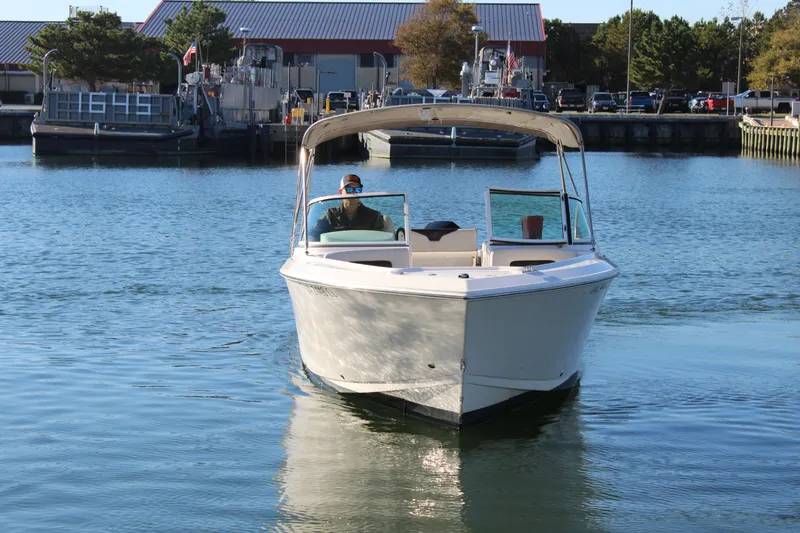 Slide: The Image of 2024 Sailfish 226DC boat on calm water. - 4