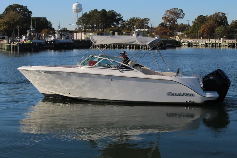 Slide: The Image of 2024 Sailfish 226DC boat on calm water in harbor. - 7