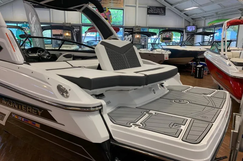 Slide: The Image of 2024 Monterey 238SS Super Sport boat displayed in showroom, featuring sleek design and spacious seating. - 4