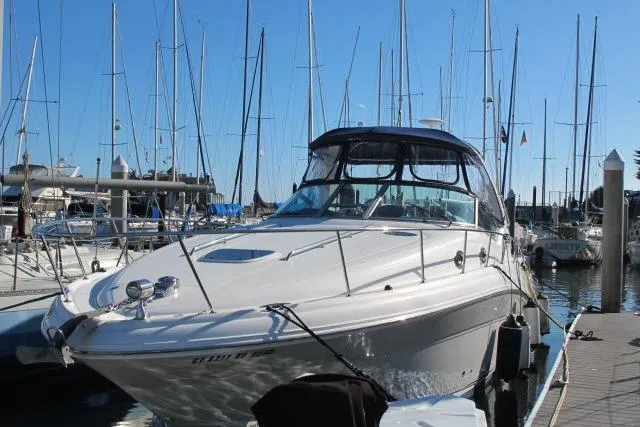The Image of 2007 Sea Ray 340 Sundancer docked at a marina with sailboats in the background. - 1