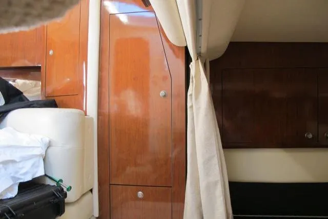 Slide: The Image of Interior of 2007 Sea Ray 340 Sundancer with wooden cabinetry and beige upholstery. - 10