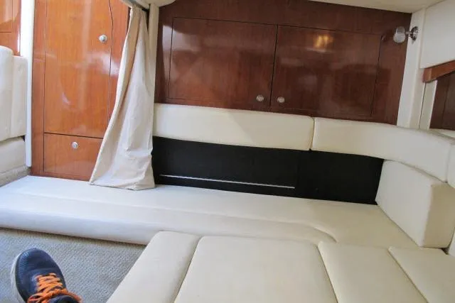 Slide: The Image of Interior of 2007 Sea Ray 340 Sundancer with beige seating and wooden cabinetry. - 13