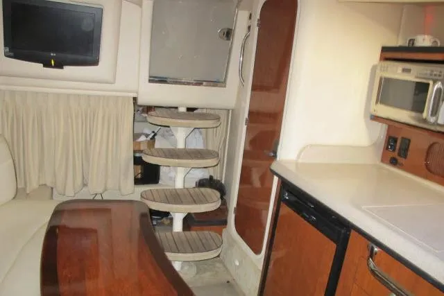 Slide: The Image of 2007 Sea Ray 340 Sundancer interior with kitchenette, stairs, and seating area. - 18