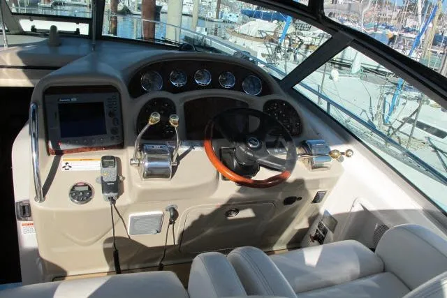 Slide: The Image of Cockpit of 2007 Sea Ray 340 Sundancer with steering wheel and navigation controls. - 27