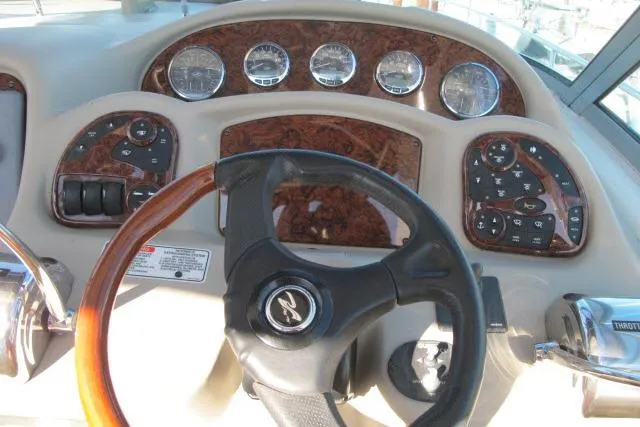Slide: The Image of 2007 Sea Ray 340 Sundancer dashboard with wood accents and steering wheel. - 28