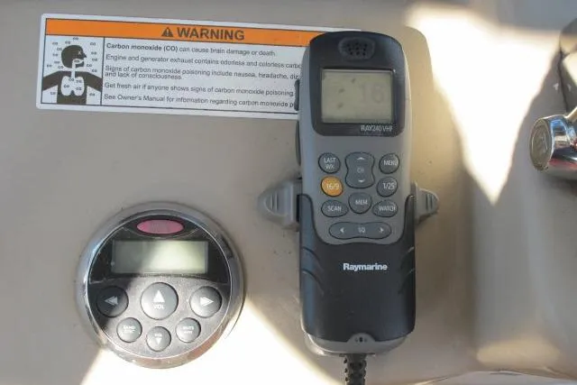 Slide: The Image of Control panel of a 2007 Sea Ray 340 Sundancer with Raymarine VHF radio and warning label. - 32