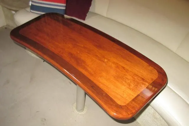 Slide: The Image of Wooden table inside 2007 Sea Ray 340 Sundancer yacht, featuring polished finish and curved edges. - 4