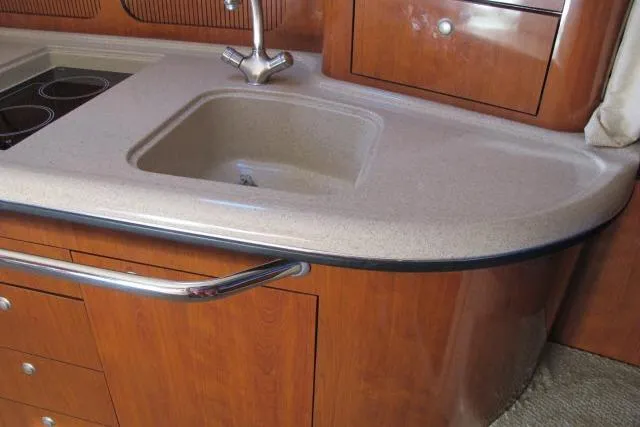Slide: The Image of 2007 Sea Ray 340 Sundancer kitchen with sink and wooden cabinetry. - 7