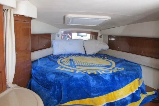 Slide: The Image of 2007 Sea Ray 340 Sundancer cabin with Golden State Warriors blanket on bed. - 8