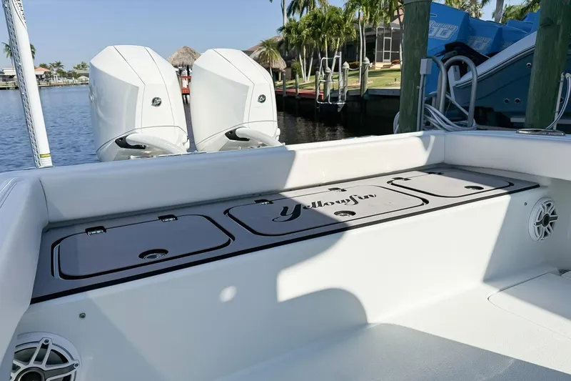Slide: The Image of 2022 Yellowfin 26 Hybrid boat with dual engines docked by waterfront. - 7