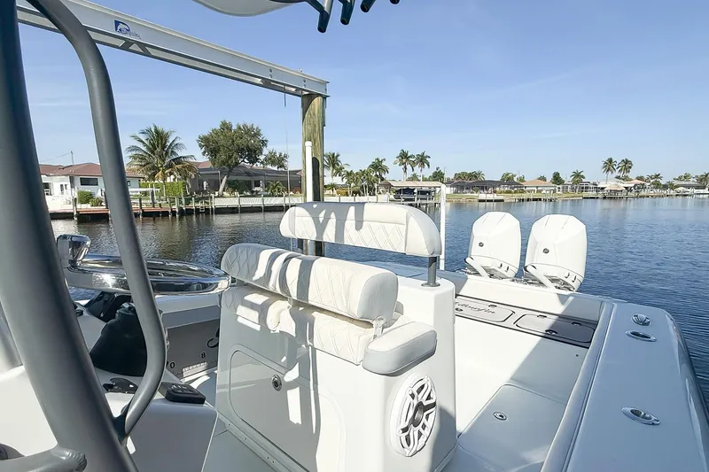 Slide: The Image of 2022 Yellowfin 26 Hybrid boat on calm water, featuring sleek design and modern amenities. - 9