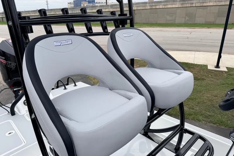 Slide: The Image of 2026 SCB R24 boat seats, sleek design, gray upholstery, outdoor setting. - 15