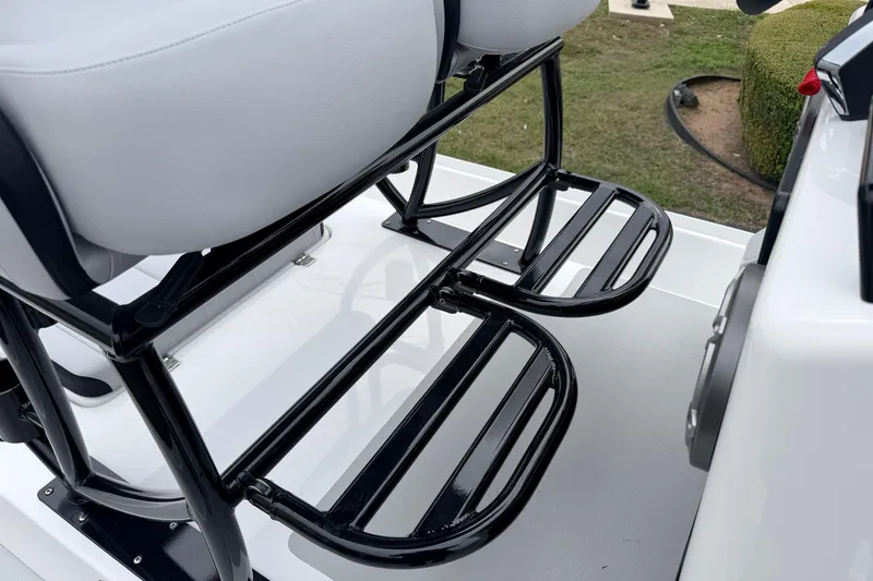 Slide: The Image of 2026 SCB R24 boat seat with black metal footrests on deck. - 16