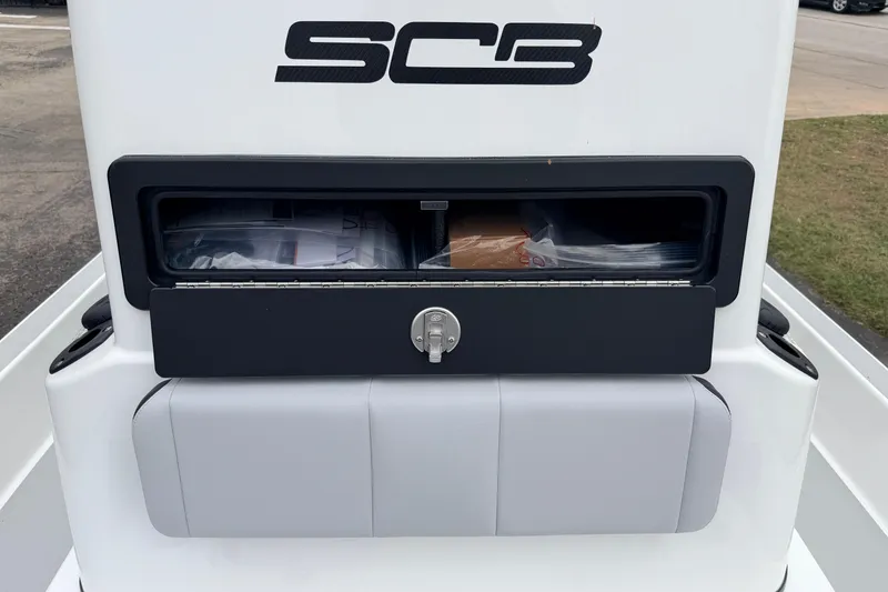 Slide: The Image of 2026 SCB R24 boat storage compartment with lock and logo. - 24