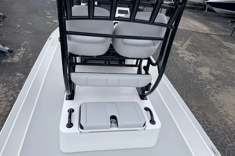 Slide: The Image of 2026 SCB R24 boat interior with seating and storage on a paved surface. - 25