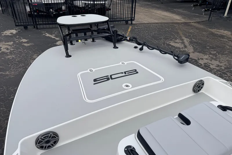 Slide: The Image of 2026 SCB R24 boat deck with trolling motor and seating, displayed outdoors. - 31